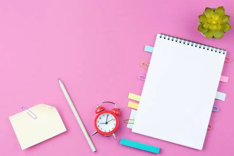 Notepad with pencil on pink background. Stock Photos