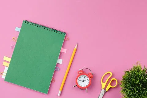 Notepad with pencil on pink background. Stock Photos