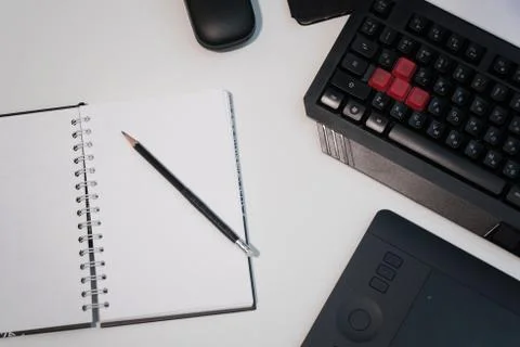 Notepad with a pencil on a white table Stock Photos