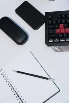 Notepad with a pencil on a white table Stock Photos