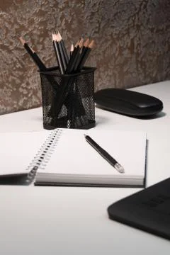 Notepad with a pencil on a white table Stock Photos