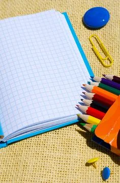 Notepad, pencils, paper clips, buttons and magnet. Stock Photos