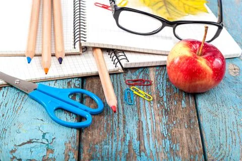 Notepad, pencils, scissors, paper clips and glasses. Stock Photos