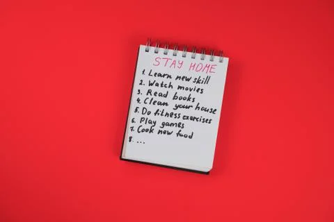 Notepad with quarantine check list on the red background. What to do at home  Stock Photos