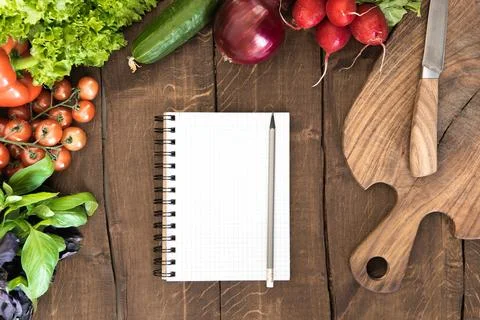 Notepad with raw vegetables Fotos Stock