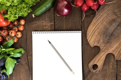 Notepad with raw vegetables 写真素材