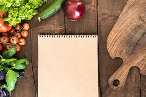Notepad with raw vegetables Фото