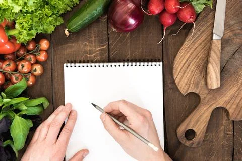 Notepad with raw vegetables Фото