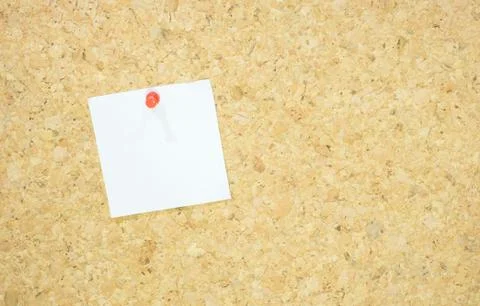 Notepad with red pushpin on corkboard Stock Photos