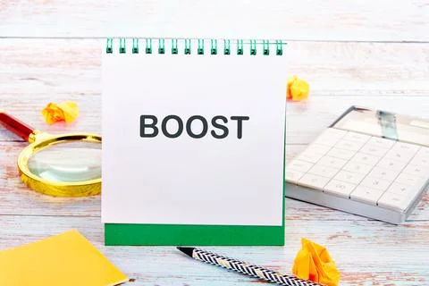 A notepad shows the word boost written in bold letters. Nearby, there is a ca 스톡 사진