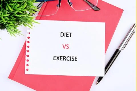 A notepad shows the words diet and exercise written in large letters. Nearby  Stock Photos