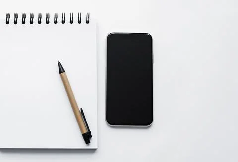 Notepad, spiral notebook, pen, on white background top view Stock-Fotos