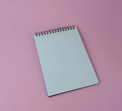 Notepad with spiral on a pink background, blank sheet. Stock Photos