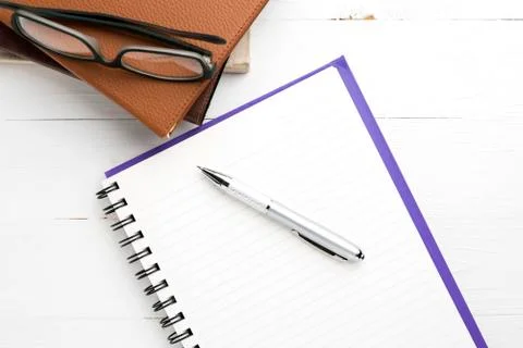 Notepad with stack of book Stock Photos