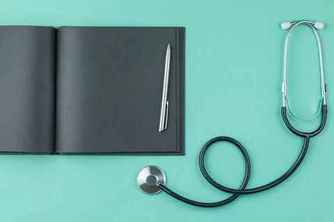 Notepad with stethoscope on the table. Stock Photos