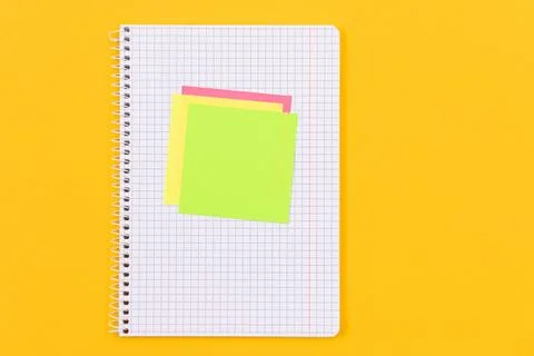A Notepad with Sticky Notes on Yellow Table Foto stock