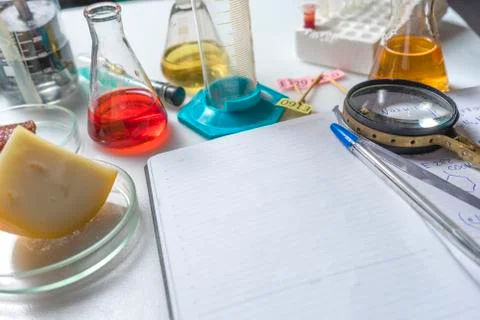 Notepad, tablets with additives E, test tubes and laboratory equipment. Food  Stock Photos