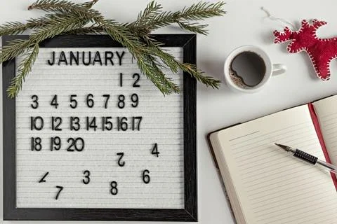 Notepad for taking notes of goals and plans for the new year, calendar,a cup  Stock Photos