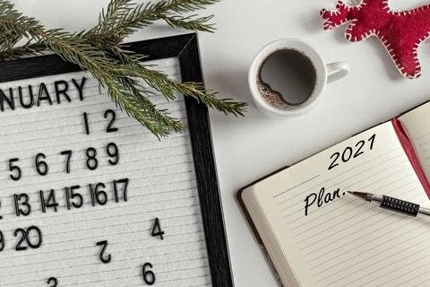 Notepad for taking notes of goals and plans for the new year, calendar,a cup  Stock Photos