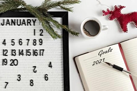 Notepad for taking notes of goals and plans for the new year,calendar, a cup  Stock Photos