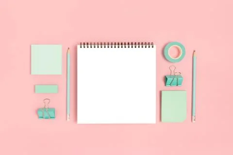 Notepad template with mint stationery on a pink pastel background. Stock Photos