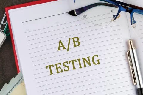 Notepad With the Term AB Testing Written in Bold Letters Alongside Glasses .. Stock Photos
