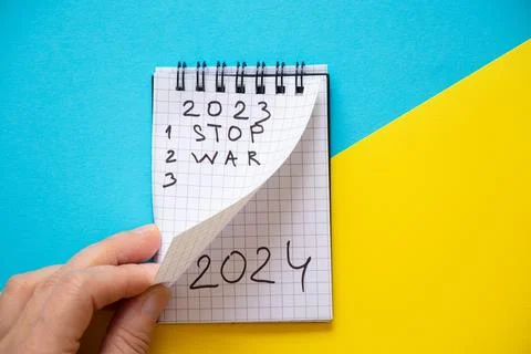 Notepad with the text 2023 and the text stop war and 2024 on the second page Stock Photos