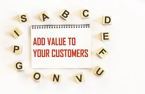 Notepad with text ADD VALUE TO YOUR CUSTOMERS . business concept 스톡 사진