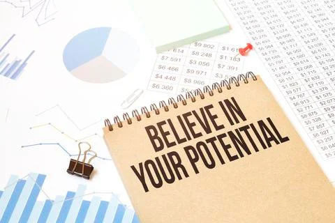 Notepad with text Believe in your potential. Diagram and white background Stock Photos