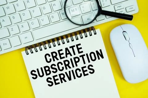 Notepad with the text "Create Subscription Services" and white keyboard, wi.. Stock Photos