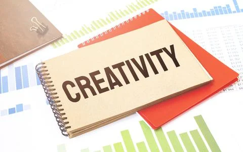 Notepad with text Creativity. Diagram, red notepad and white background Stock Photos