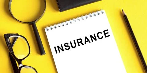 Notepad with the text INSURANCE on a yellow background with glasses, a magnif Stock Photos