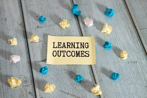Notepad with text Learning outcomes on the business charts and pen, business. Stock Photos