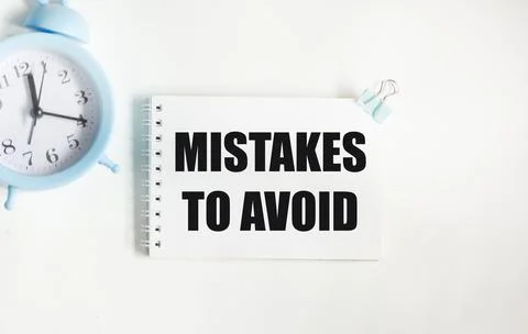 Notepad with text MISTAKES TO AVOID on a white background 写真素材