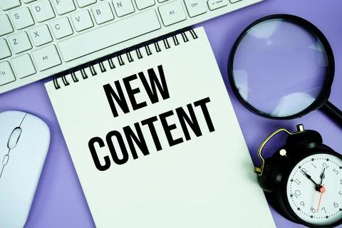 Notepad with the text "New Content" and white keyboard, wireless mouse, mag.. Stock Photos