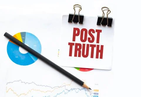 Notepad with text POST TRUTH on business charts and pen Stock Photos