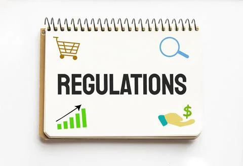 Notepad with text REGULATIONS. White background. Business Stock Photos