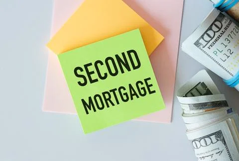 Notepad with text Second Mortgage lying on financial tables with a money Stock Photos
