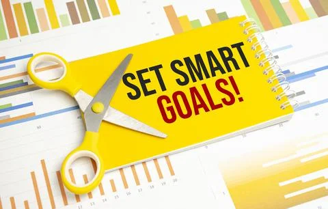 A notepad with the text set SMART goals pen, reports, Stock Photos