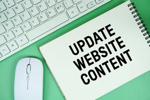 Notepad with the text "Update Website Content" and white keyboard and wirel.. Stock Photos