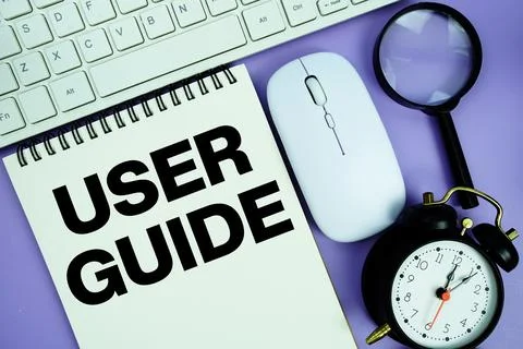 Notepad with the text "User Guide" and white keyboard, wireless mouse, magn.. Stock Photos
