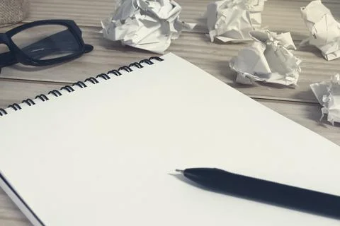Notepad with trash paper background on office desk. Copy space. Stock Photos