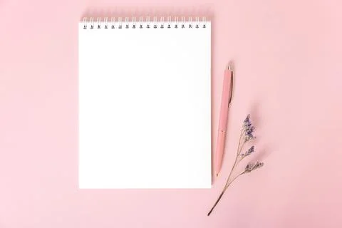 Notepad with white blank sheets, pink pen and dried flower sprig Stock Photos