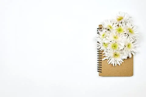 A notepad with white flowers Stock Photos