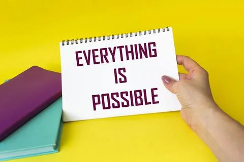 Notepad in woman's hand, with the phrase - everything is possible - conceptua Stock Photos