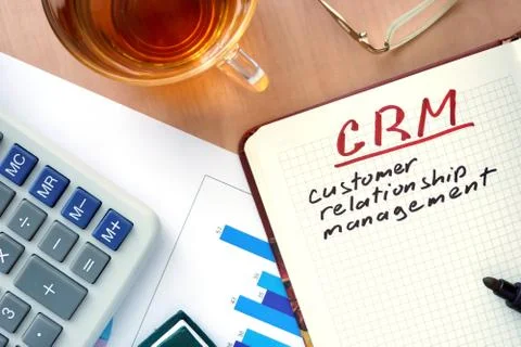 Notepad with words CRM customer relationship management and marker. Stock Photos