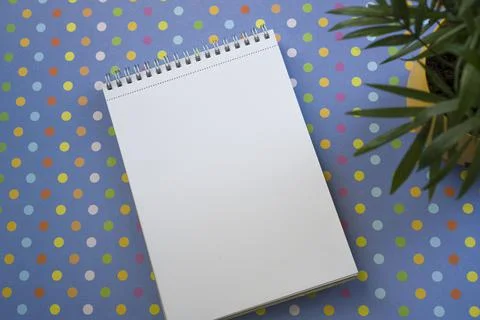 Notepad for writing down ideas on a bright background. Green plants. Stock Photos