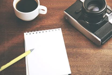 Notepad,coffee and camera Stock Photos