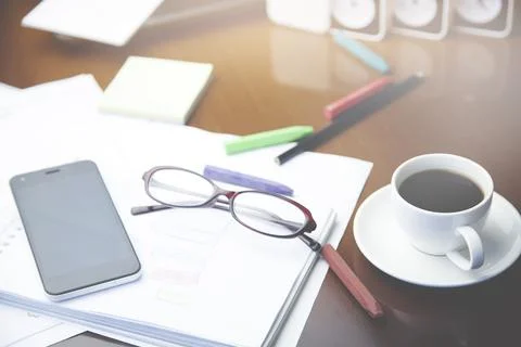 Notepad,pencils,coffee and glasses on table Stock Photos