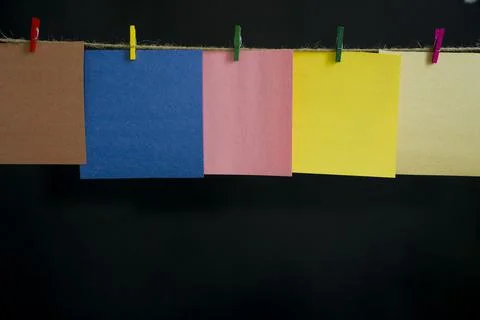 Notes on a black background. Hanging in the air. Stock Photos
